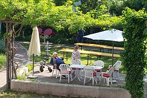 Blick von Oben in den Garten des Elisabeth-Maas-Hauses, mit Tischen und Sonnenschirmen
